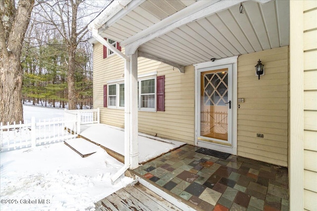 view of snow covered property entrance