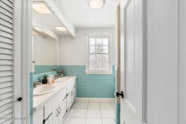 bathroom featuring tile patterned flooring, vanity, and tile walls