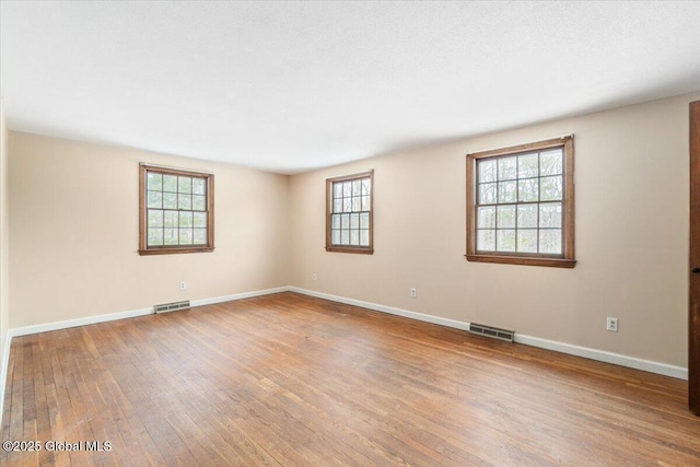 spare room with hardwood / wood-style flooring