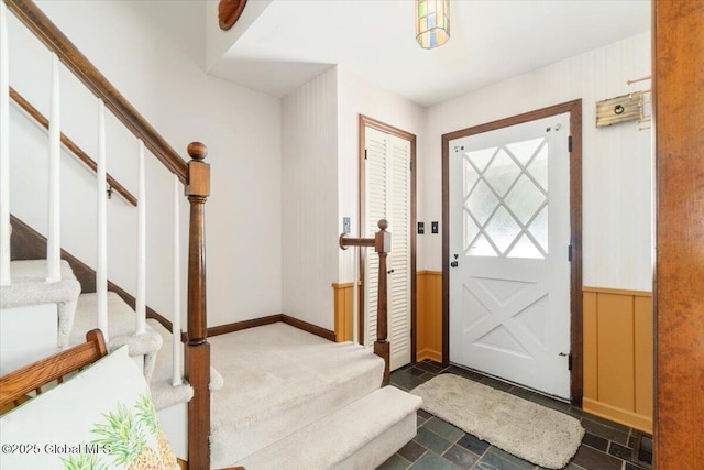 entryway featuring wood walls