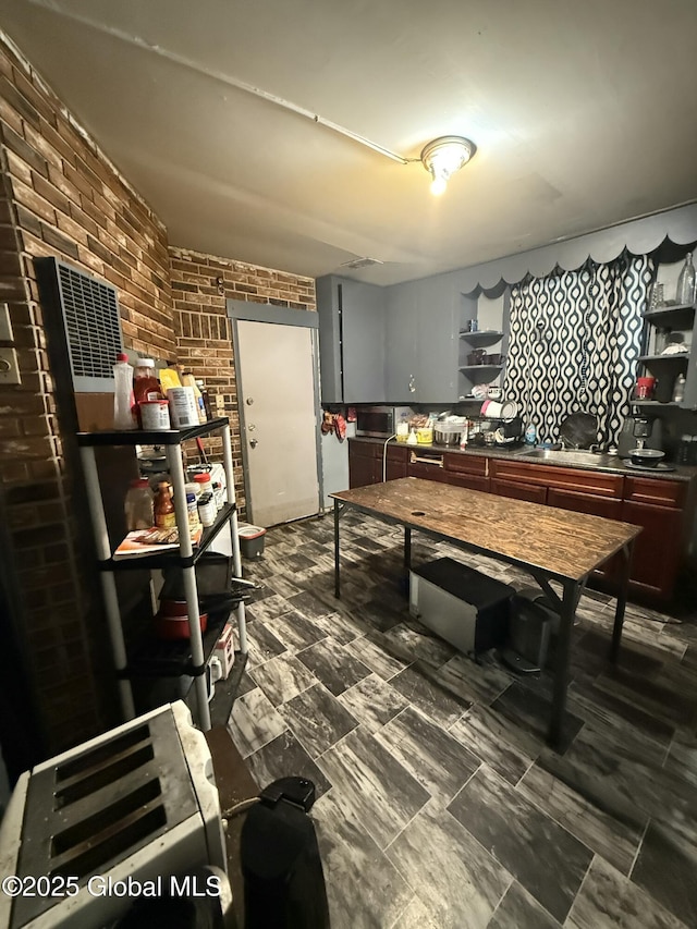 kitchen featuring brick wall