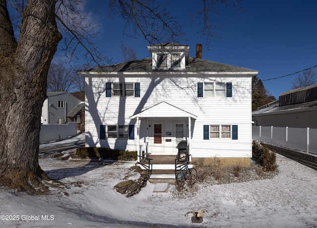 colonial-style house featuring covered porch