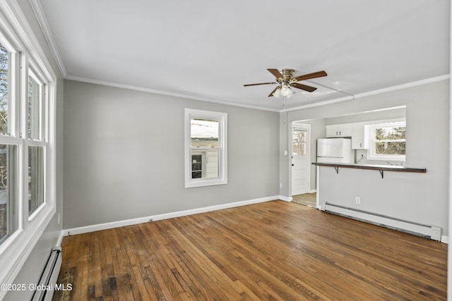 unfurnished living room with dark wood-type flooring, a baseboard radiator, and plenty of natural light