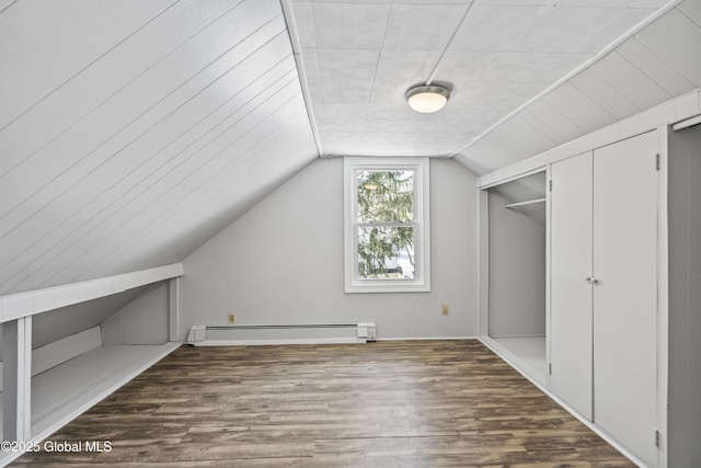 additional living space with vaulted ceiling, wood-type flooring, and baseboard heating