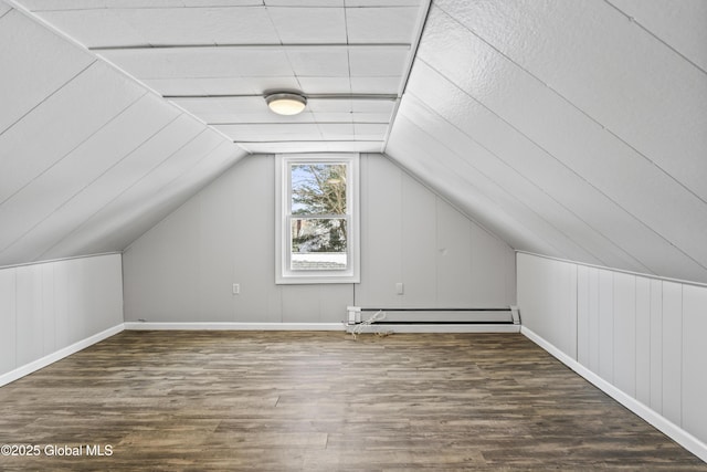 bonus room with lofted ceiling, a baseboard heating unit, and dark wood-type flooring