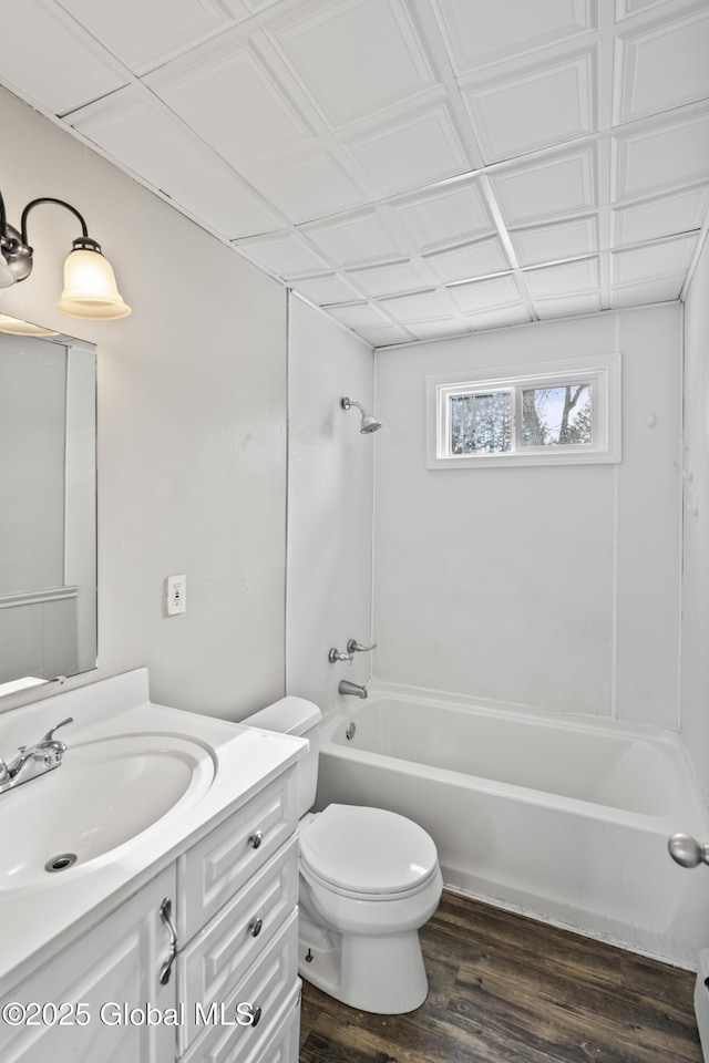 full bathroom with vanity, toilet, hardwood / wood-style floors, and shower / bathing tub combination