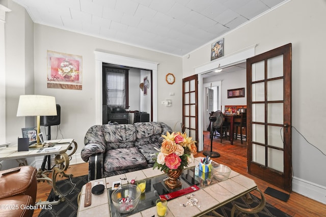 living room with ornamental molding and hardwood / wood-style floors