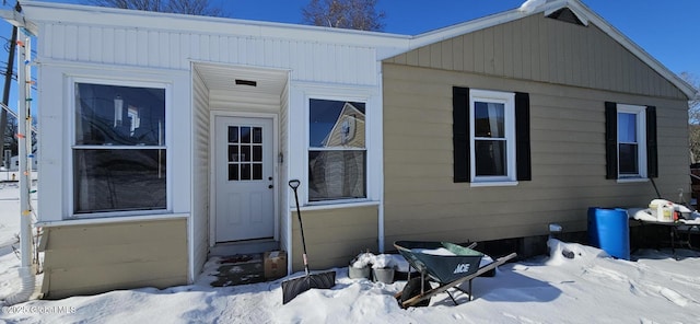 view of snow covered property entrance