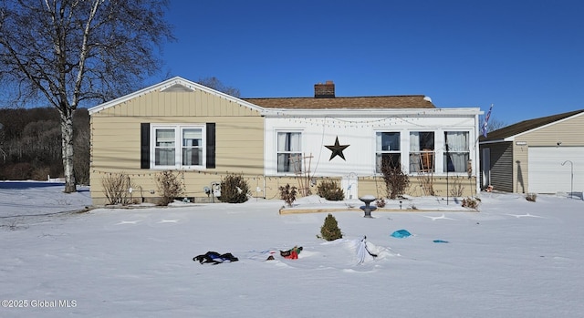 view of front of house featuring a garage and an outdoor structure