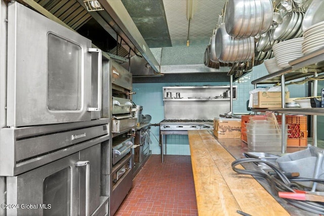 kitchen featuring butcher block countertops and backsplash