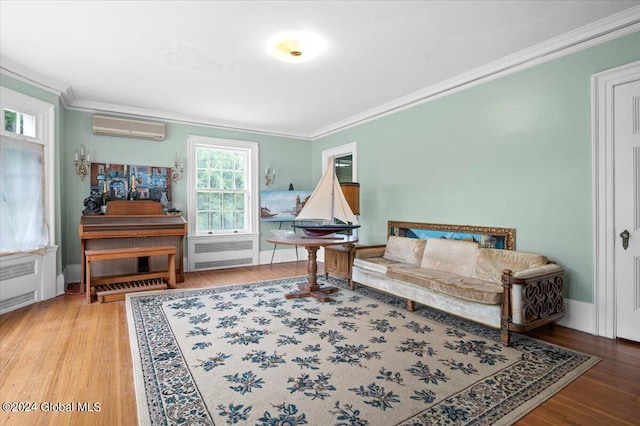 living area featuring hardwood / wood-style floors, crown molding, radiator, and a wall mounted air conditioner