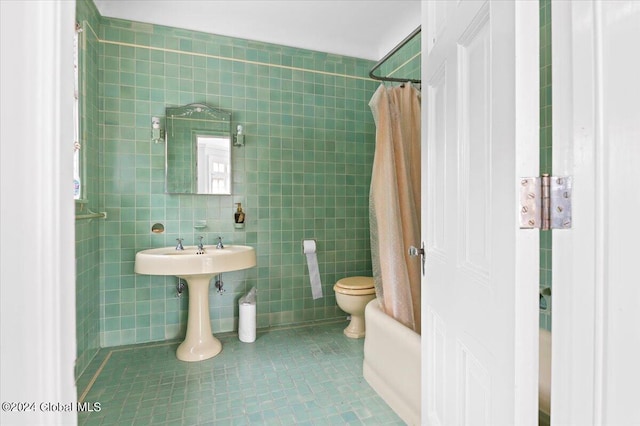 bathroom with tile walls, tile patterned floors, toilet, and shower / bathtub combination with curtain