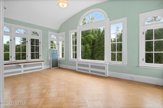 unfurnished sunroom featuring vaulted ceiling