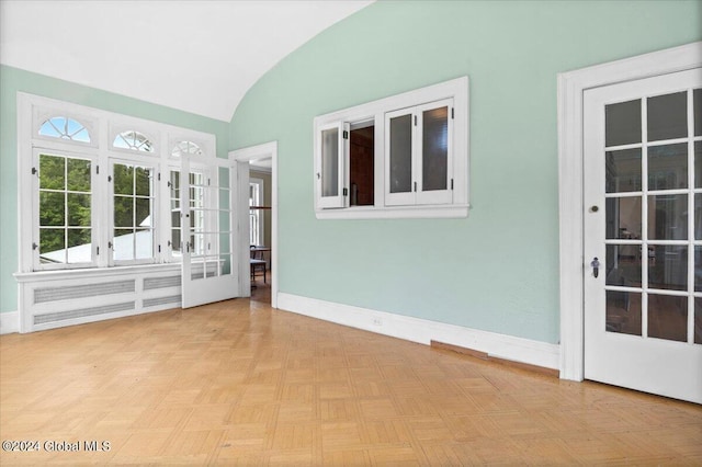 unfurnished sunroom with lofted ceiling and brick ceiling