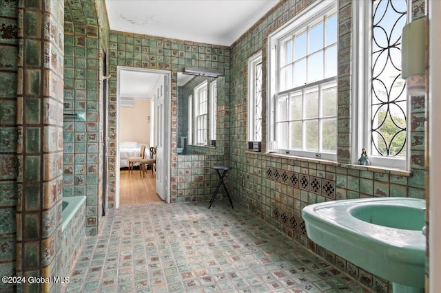 bathroom with crown molding and a bathing tub