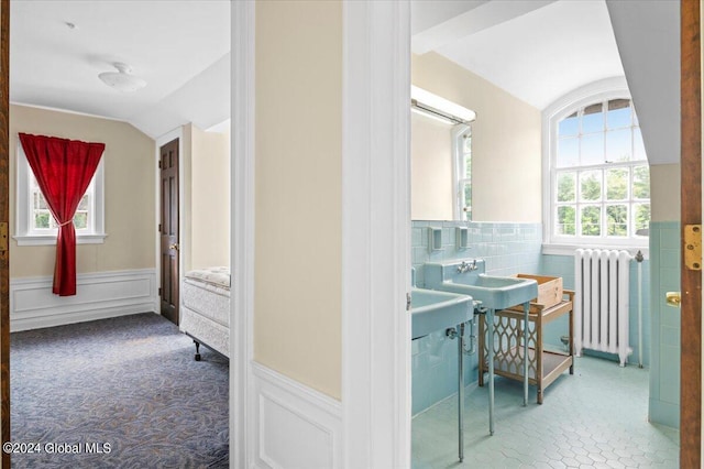 bathroom with vaulted ceiling and radiator