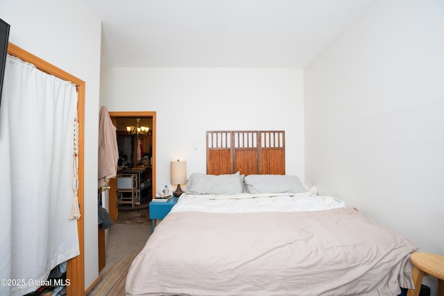 carpeted bedroom featuring a chandelier