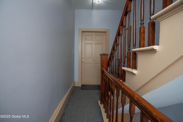 hallway featuring dark carpet