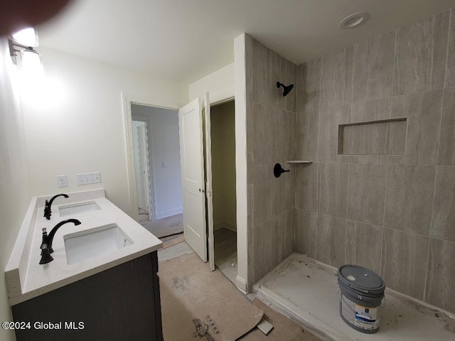 bathroom featuring vanity and tiled shower