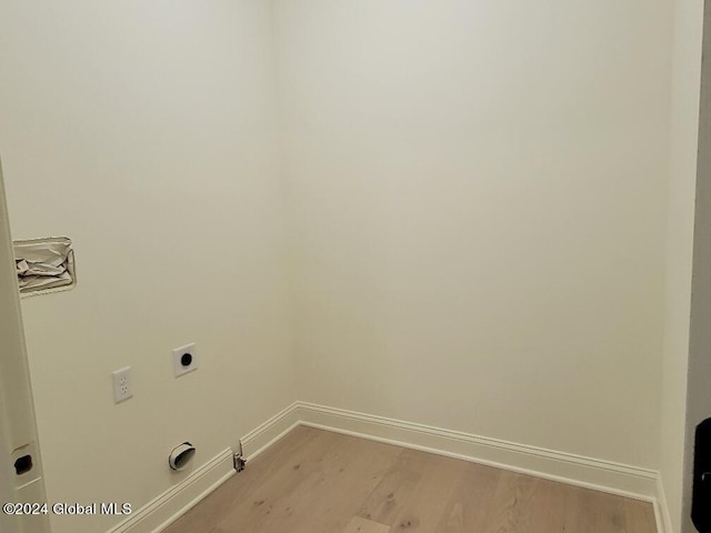 laundry room featuring electric dryer hookup, hookup for a gas dryer, and light hardwood / wood-style flooring