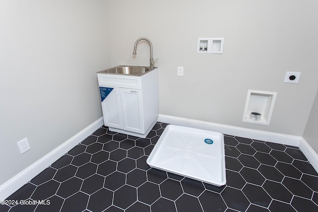 laundry area featuring sink, cabinets, dark tile patterned floors, hookup for a washing machine, and electric dryer hookup