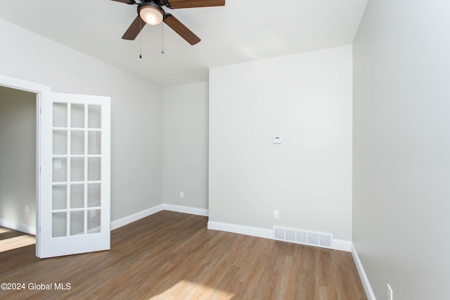 empty room featuring hardwood / wood-style flooring and ceiling fan