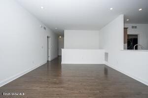 spare room featuring dark wood-type flooring