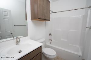 full bathroom with vanity, shower / bathtub combination, and toilet