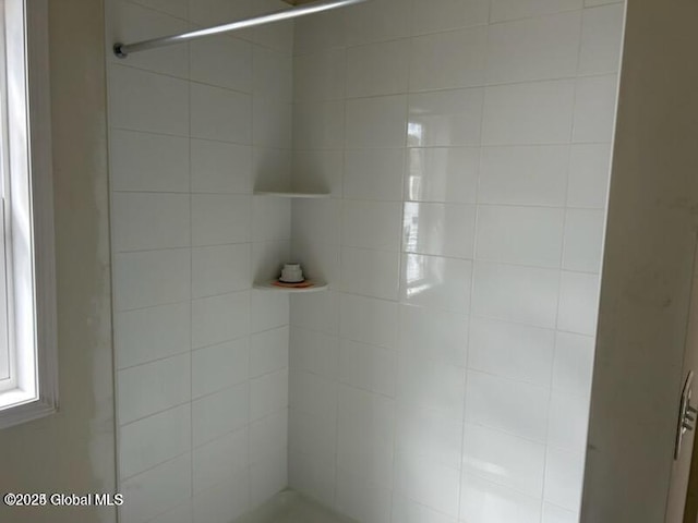 bathroom with a tile shower