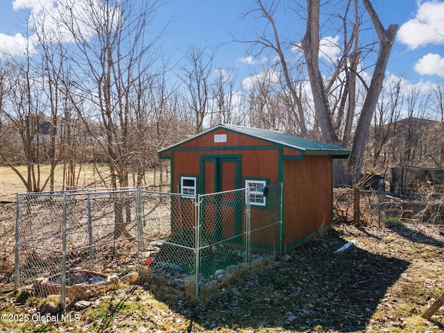 view of shed featuring fence