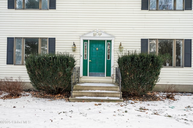 view of snow covered property entrance