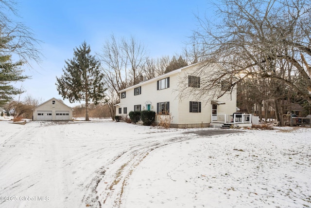 view of front of home with a garage and an outbuilding