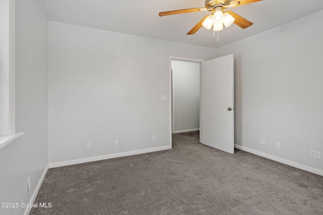 carpeted empty room featuring ceiling fan