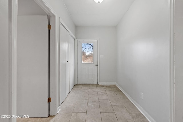 doorway to outside with light tile patterned flooring