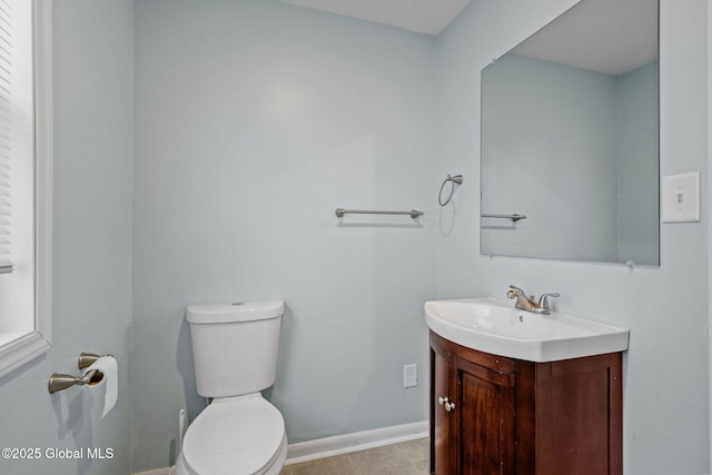 bathroom with tile patterned flooring, vanity, and toilet