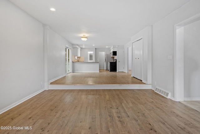 unfurnished living room featuring light wood-type flooring