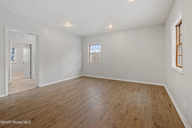 spare room featuring a wealth of natural light and light wood-type flooring