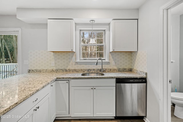 kitchen featuring white cabinetry, dishwasher, sink, and decorative backsplash