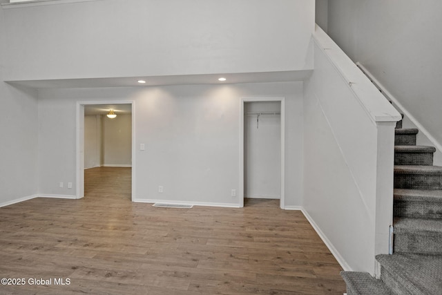 basement with hardwood / wood-style floors