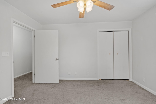 unfurnished bedroom with light carpet, ceiling fan, and a closet