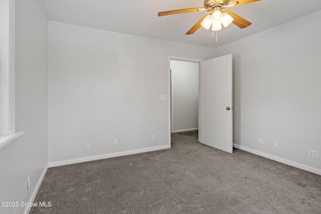 empty room featuring carpet flooring and ceiling fan