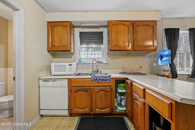 kitchen featuring sink and white appliances