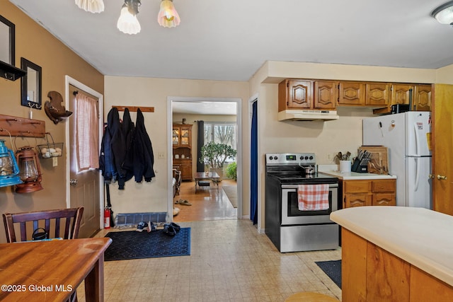 kitchen with stainless steel electric range oven and white fridge