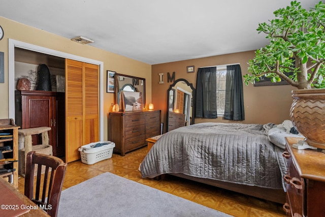 bedroom featuring a closet and light parquet floors