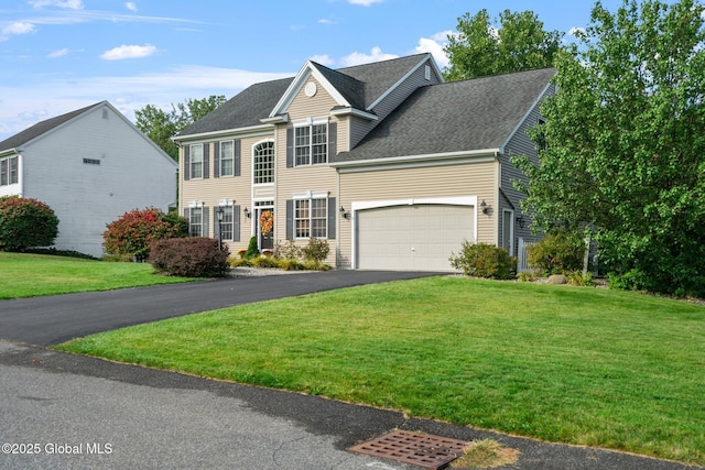 view of front facade with a garage and a front lawn