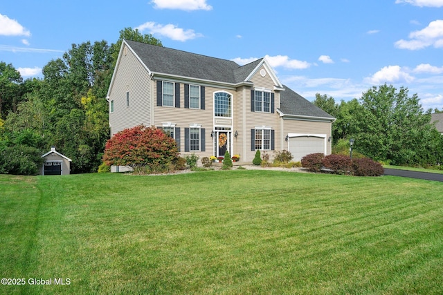 view of front of property featuring a garage and a front lawn