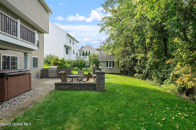 view of yard with area for grilling, an outbuilding, a hot tub, and a patio