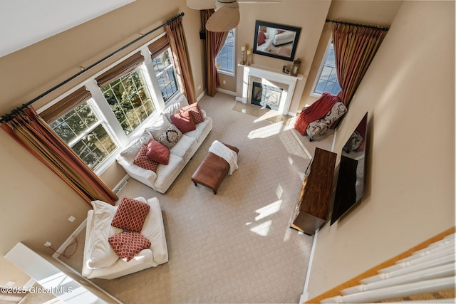 living room with a fireplace and light carpet