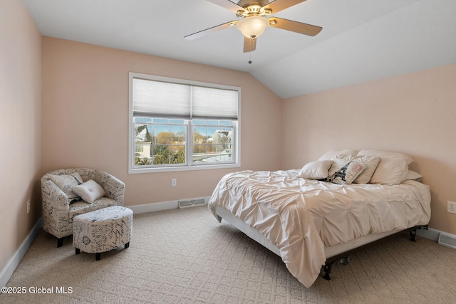 bedroom with ceiling fan, lofted ceiling, and carpet floors