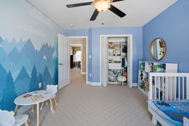 bedroom featuring light carpet, ceiling fan, and a closet